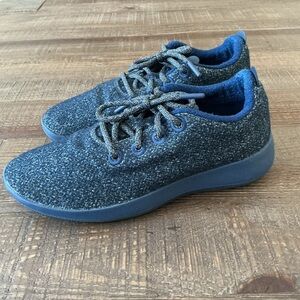 Allbirds Wool Runners in a dark grey/navy color with blue trim and grey laces.